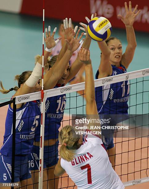 Russia' Liubov Shashkova ,Yulia Merkulova and Ekaterina Gamova block as Poland's Malgorzata Glinka attempts to score during their small final for the...