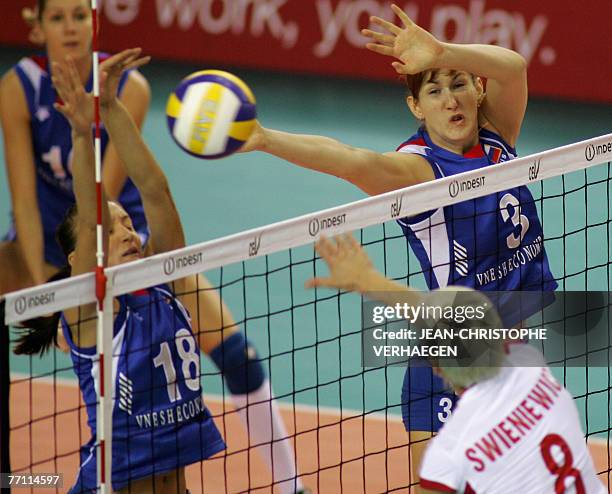 Russia's Marina Akulova and Natalia Sedova block Poland's Dorota Swieniewicz attack during their match for the third place match of the European...