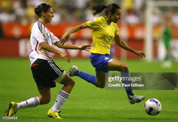 Marta Vieira Da Silva of Brazil battles for the ball with Linda Bresonik of Germany during the Women's World Cup 2007 Final between Brazil and...