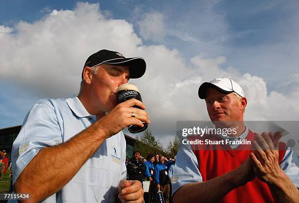 Phillip Archer and Simon Dyson of The Great Britain and Ireland Team celebrate their teams win with a pint of Guinness after the final day singles at...