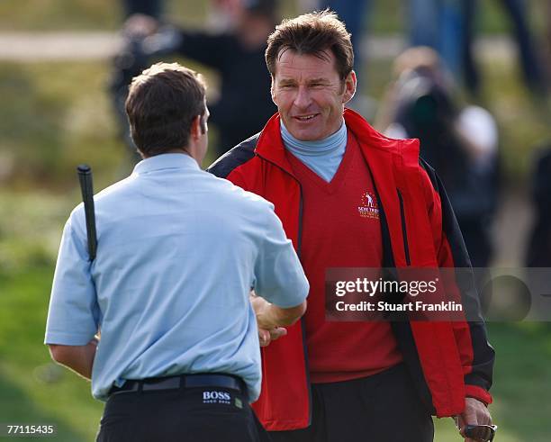 Bradley Dredge shakes hands with Captain Nick Faldo of The Great Britain and Ireland Team after the final day singles at the Seve Trophy 2007 held at...