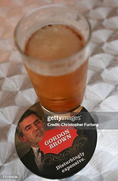Pint of lager sits on a beer mat depicting British Prime Minister Gordon Brown at the 2007 Conservative Conference at Blackpool's Winter Gardens, on...