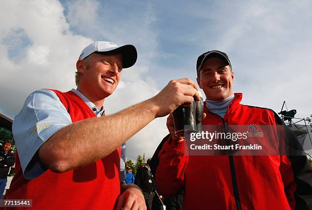 Simon Dyson and Marc Warren of The Great Britain and Ireland Team celebrate their teams win with a pint of Guinness after the final day singles at...