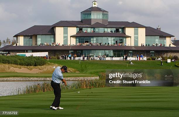 Bradley Dredge of The Great Britain and Ireland Team plays his approach shot on the 18th hole during the final day singles at the Seve Trophy 2007...