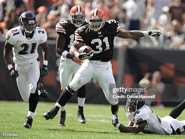 Jamal Lewis of the Cleveland Browns gains a first down as he steps through the tackle attempt of Dawan Landry of the Baltimore Ravens as Landry's...