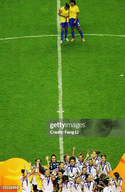 The German team celebrate victory on the podium after winning the Women's World Cup 2007 Final match between Brazil and Germany at the Shanghai...