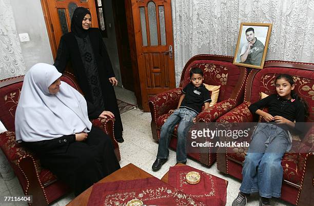 Oula Adnan Hasanen displays a picture of her husband Abdelhadi Hasan Hasanen who has spent six years of a 12-year sentence in an Israeli prison, as...