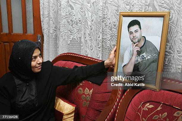 Oula Adnan Hasanen looks at a picture of her husband Abdelhadi Hasan Hasanen who has spent six years of a 12-year sentence in an Israeli prison...