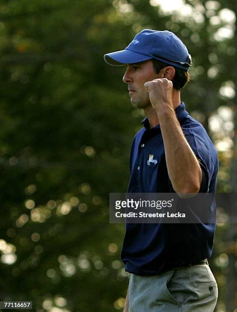 Mike Weir of the International Team celebrates after making a putt on the 17th hole during his match against Tiger Woods of the U.S. Team during the...