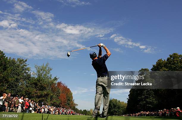 Mike Weir of Canada and the International Team watches his tee shot on the third hole during the final day singles matches at the Presidents Cup at...