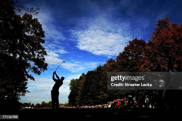 Tiger Woods of the U.S. Team hits his tee shot on the 15th hole during the final day singles matches at the Presidents Cup at The Royal Montreal Golf...