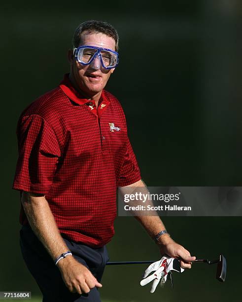 Woody Austin of the U.S. Team walks to the 14th green wearing a dive mask during the final day singles matches at The Presidents Cup at The Royal...