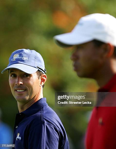 Mike Weir of the International Team looks over at Tiger Woods of the U.S. Team during the final day singles matches at The Presidents Cup at The...