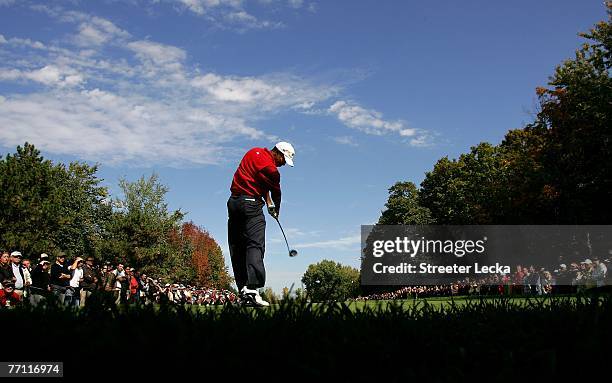 Tiger Woods of the U.S. Team hits his tee shot on the 3rd hole during the final day singles matches at The Presidents Cup at The Royal Montreal Golf...