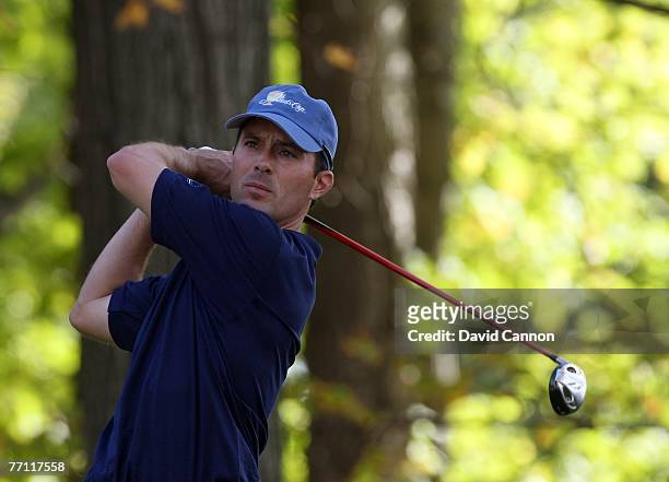 Mike Weir of the International Team plays his tee shot at the 15th hole during the final day singles matches at the Presidents Cup at Royal Montreal...