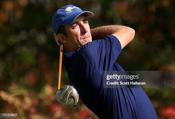 Geoff Ogilvy of the International team hits his tee shot on the fourth hole during the final day singles matches at The Presidents Cup at The Royal...