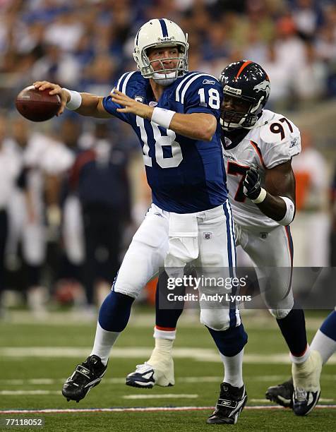 Peyton Manning of the Indianapolis Colts prepares to throw a pass while pursued by Simeon Rice of the Denver Broncos during the NFL game on September...