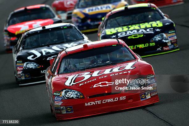 Dale Earnhardt Jr., driver of the Budweiser Chevrolet, leads Clint Bowyer, driver of the Jack Daniel's Chevrolet and Casey Mears, driver of the...