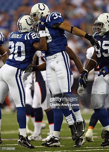 Melvin Bullitt and Dante Hughes of the Indianapolis Colts celebrate after a defensive stop against the Denver Broncos during the NFL game on...