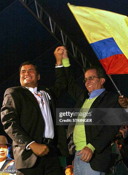 Ecuadorean President Rafael Correa and main candidate for Acuerdo Pais party Alberto Acosta celebrate with a national flag after getting a majority...