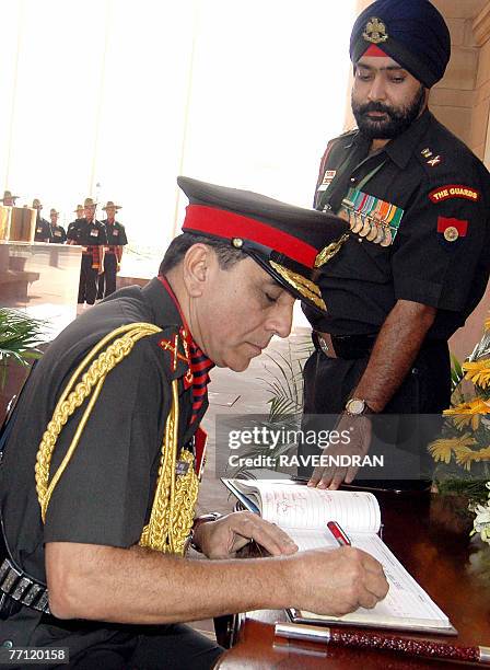 India's new Chief of Army Staff General Deepak Kapoor signs a register after paying his respects to the fallen soldiers of the Indian Army at Amar...