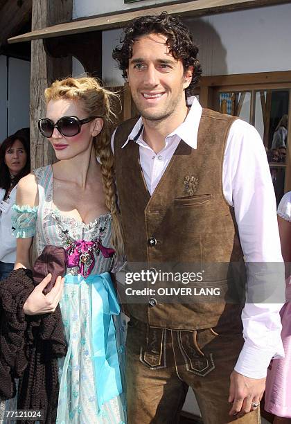 Bayern Munich's Italian striker Luca Toni and his girlfriend Marta Cecchetto pose for a photo wearing traditional Bavarian clothes as the visit the...