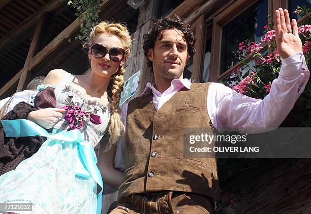 Bayern Munich's Italian striker Luca Toni and his girlfriend Marta Cecchetto pose for a photo wearing traditional Bavarian clothes as the visit the...