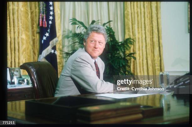 President Clinton sits at his desk in the Oval Office July 6, 1993 in Washington, DC. The President is scheduled to leave for Tokyo, Japan later...
