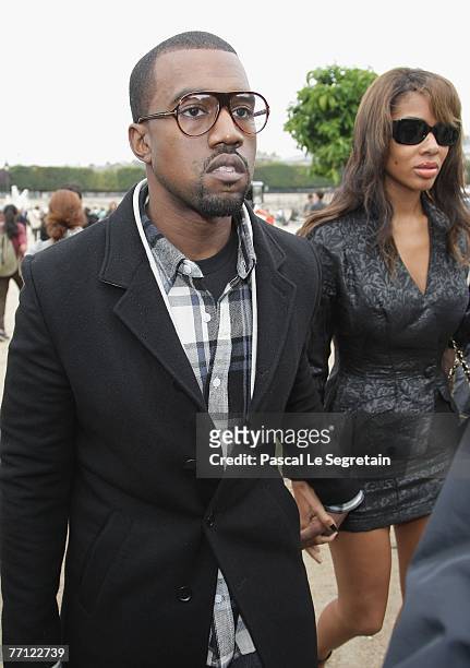 Musician Kanye West arrives with Alexis Phifer to attend the Christian Dior Fashion show during the Sping/ Summer 08 fashion week on October 1, 2007...