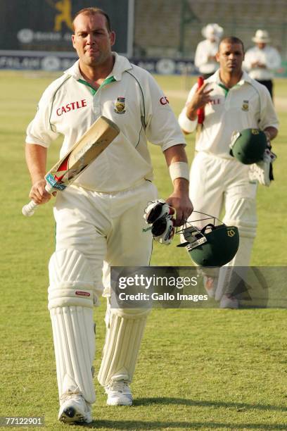 Jacques Kallis walks off the pitch with 118 runsnot out with Ashwell Prince behind him during day one of the first Test match series between Pakistan...