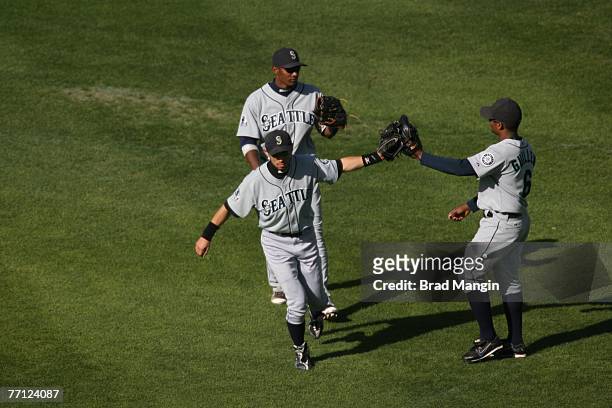 Ichiro Suzuki, Jose Guillen and Adam Jones of the Seattle Mariners celebrate win after the game against the Oakland Athletics at the McAfee Coliseum...