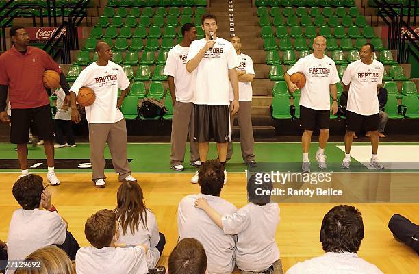 Andrea Bargnani of the Toronto Raptors addresses attendees while team members head coach Sam Mitchell, T.J. Ford, Chris Bosh, Anthony Parker and...