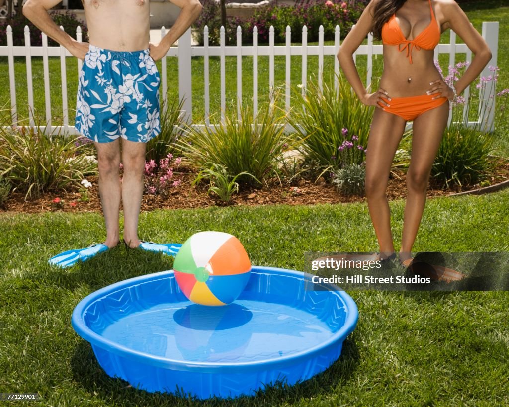 Multi-ethnic couple next to kiddie pool