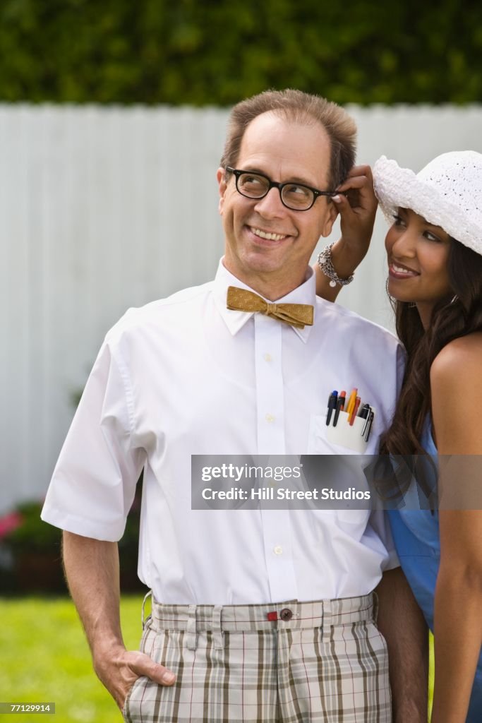 Nerdy man with beautiful girlfriend