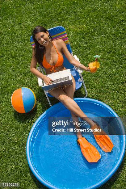 hispanic woman in bikini next to kiddie pool - swimming pool hill stock pictures, royalty-free photos & images