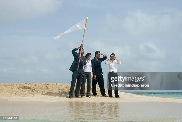 multi-ethnic businesspeople with flag at beach - sos stock pictures, royalty-free photos & images