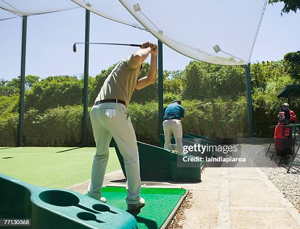 hispanic man playing golf - driving range stock pictures, royalty-free photos & images