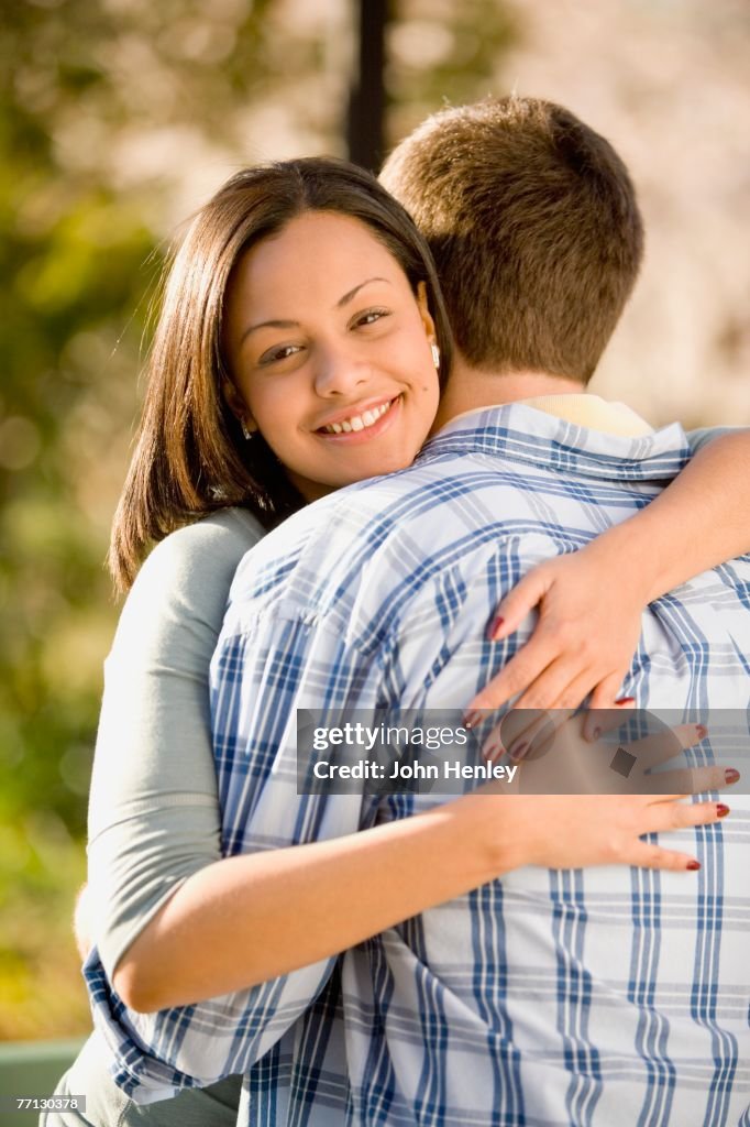 Hispanic woman hugging boyfriend