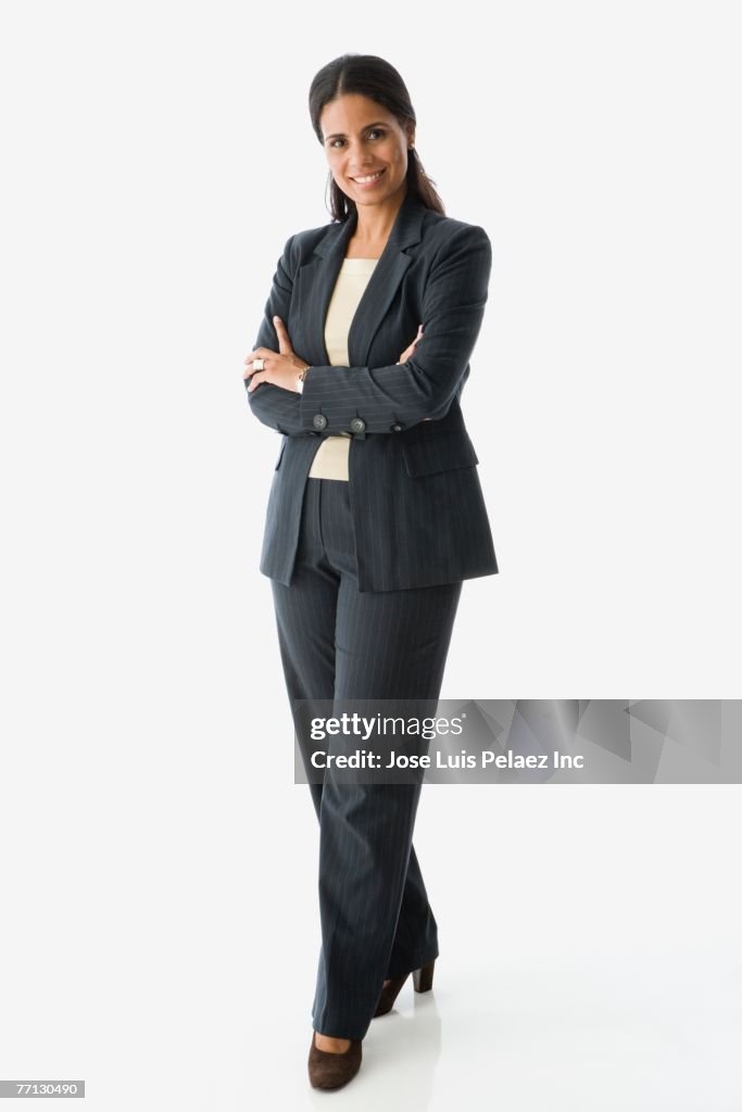 Hispanic businesswoman with arms crossed