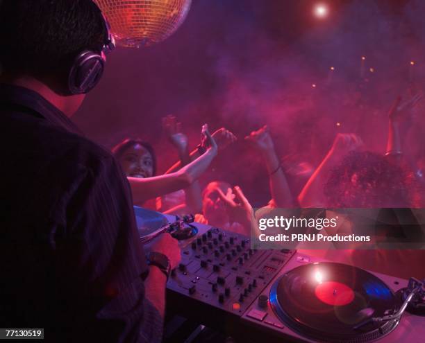 hispanic dj playing at nightclub - dj party stock-fotos und bilder