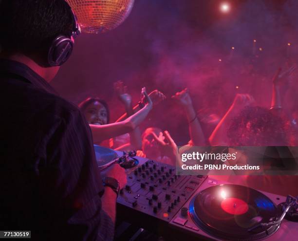 hispanic dj playing at nightclub - dj club foto e immagini stock