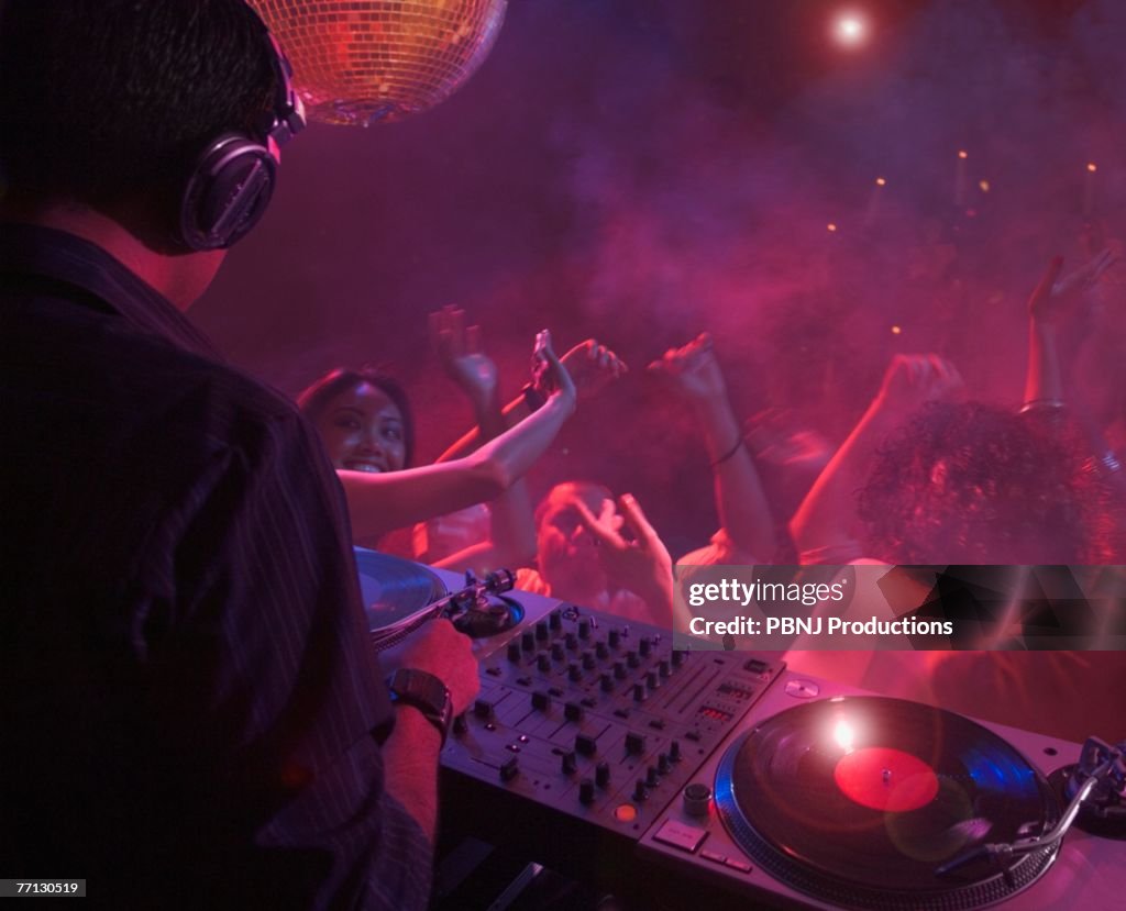 Hispanic dj playing at nightclub