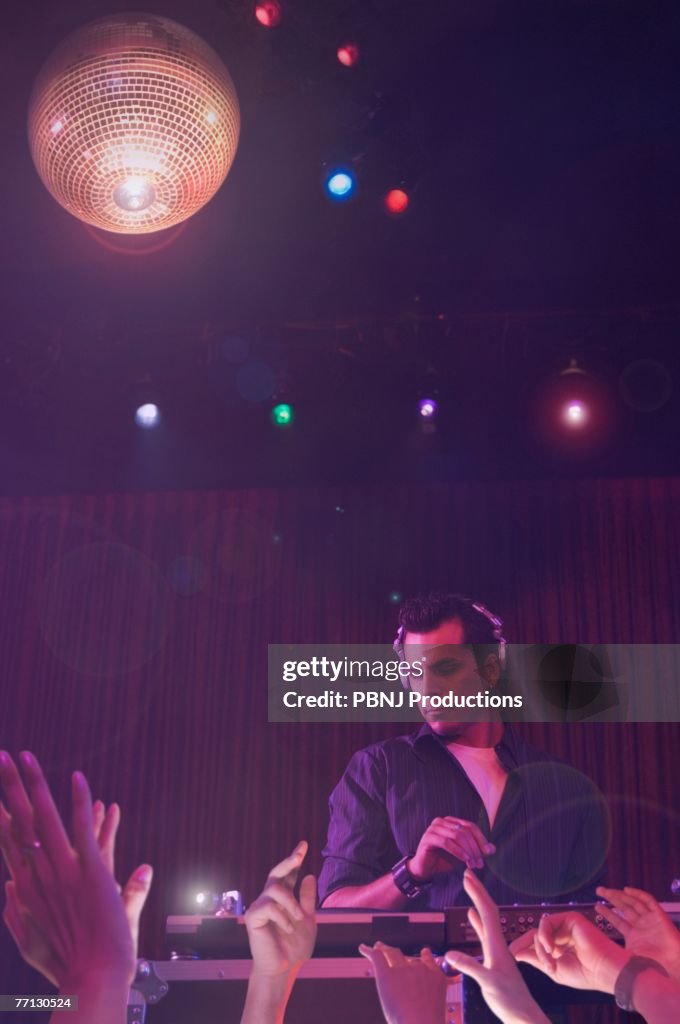 Hispanic dj playing at nightclub