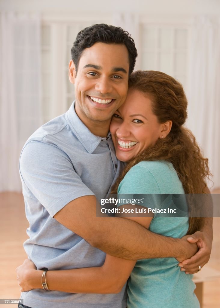 Hispanic Couple Hugging High-Res Stock Photo - Getty Images