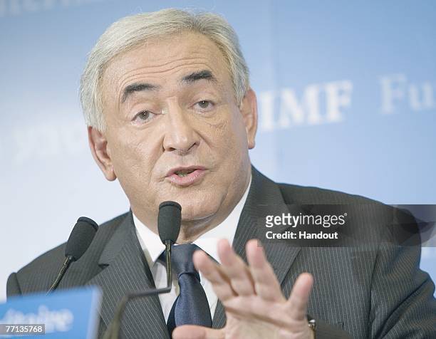 In this handout photo supplied by the International Monetary Fund , Former French Finance Minister Dominique Strauss-Kahn and newly appointed...