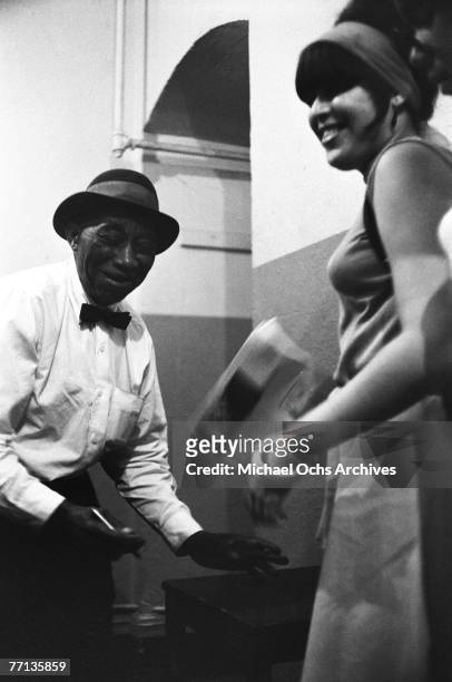 Legendary bluesman Mississippi John Hurt prepares to go onstage at the New York Folk Festival in July of 1965 at Carnegie Hall in New York, New York.