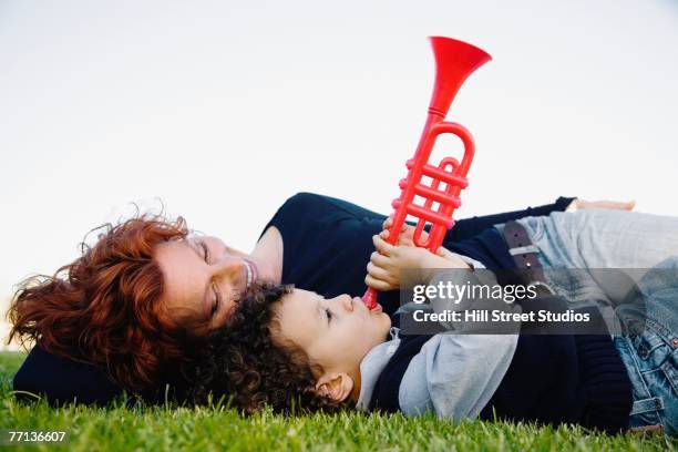 mother and son laying in grass - egyptian family stock pictures, royalty-free photos & images