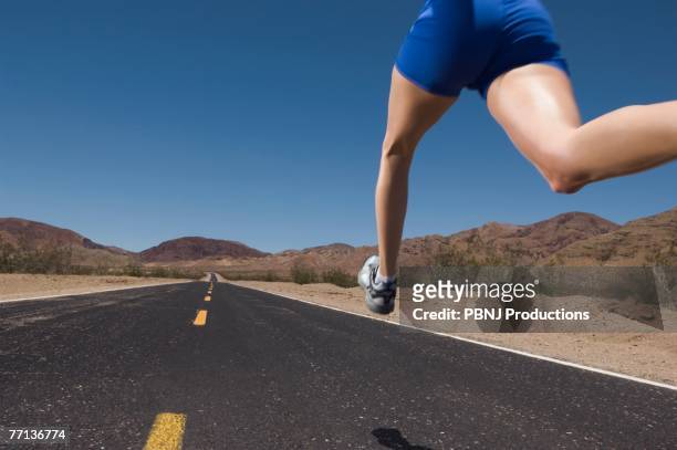 mixed race woman running on road - marathon start stock pictures, royalty-free photos & images