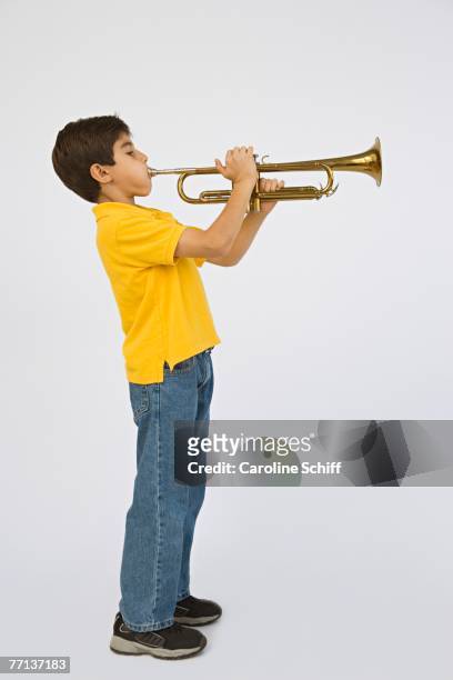 middle eastern boy playing trumpet - blechblasinstrument stock-fotos und bilder