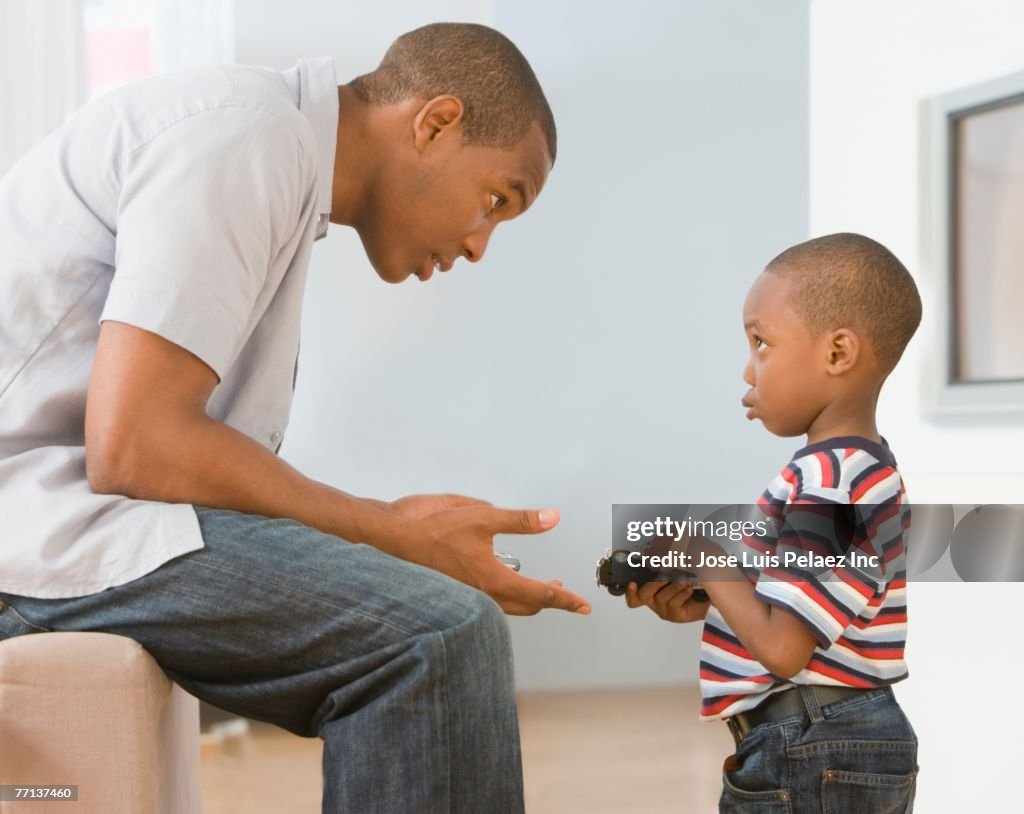 African American father talking to son